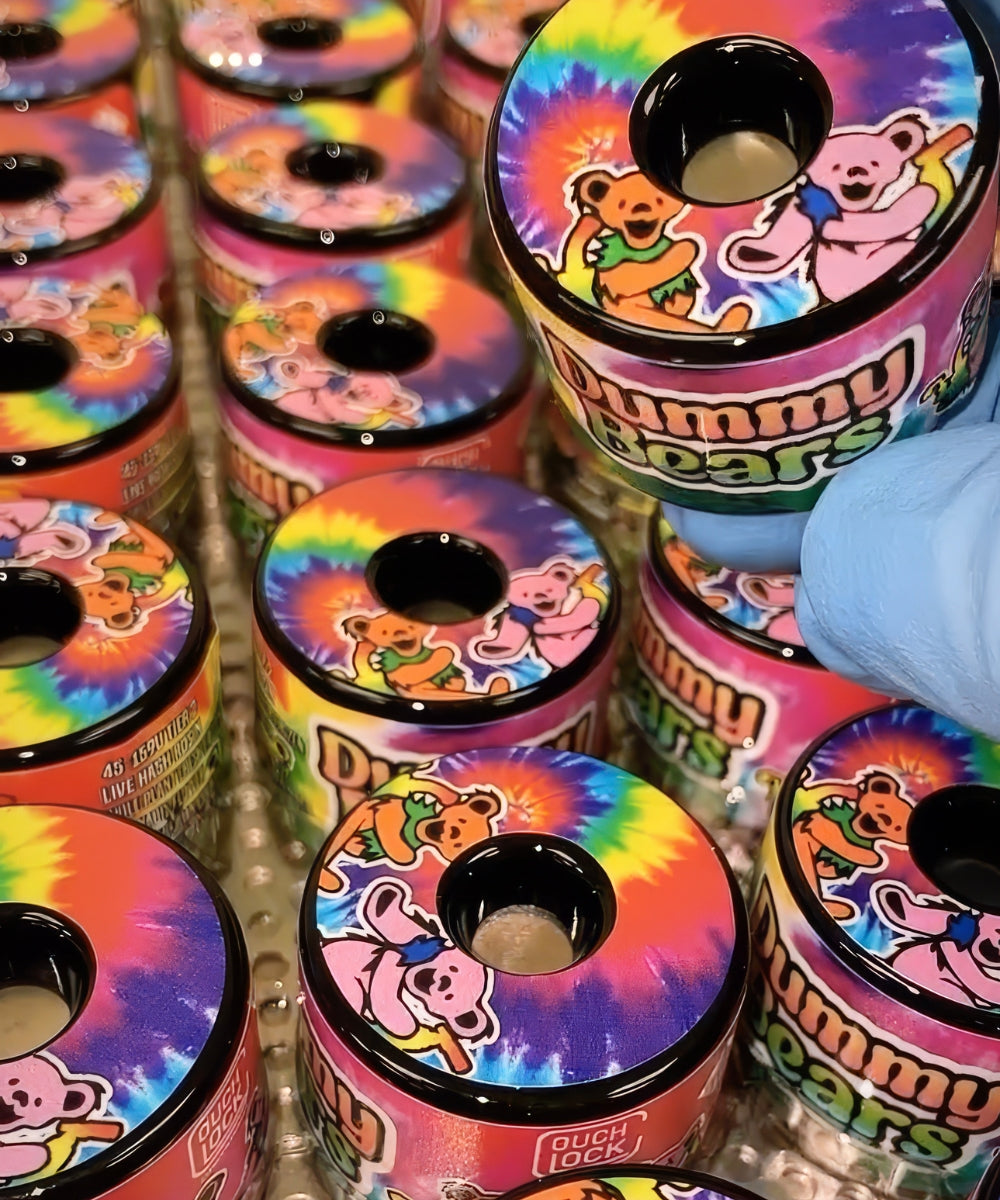 Couch Lock Concentrates' Grateful Dead tie dye branding on Pop Vac jars with labels made by Vert